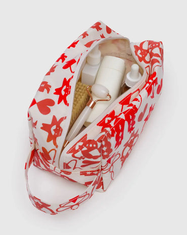 Side profile of Baggu Cowgirl Dopp kit featuring a loop for carrying or hanging, ideal for travel or gifting gift shop