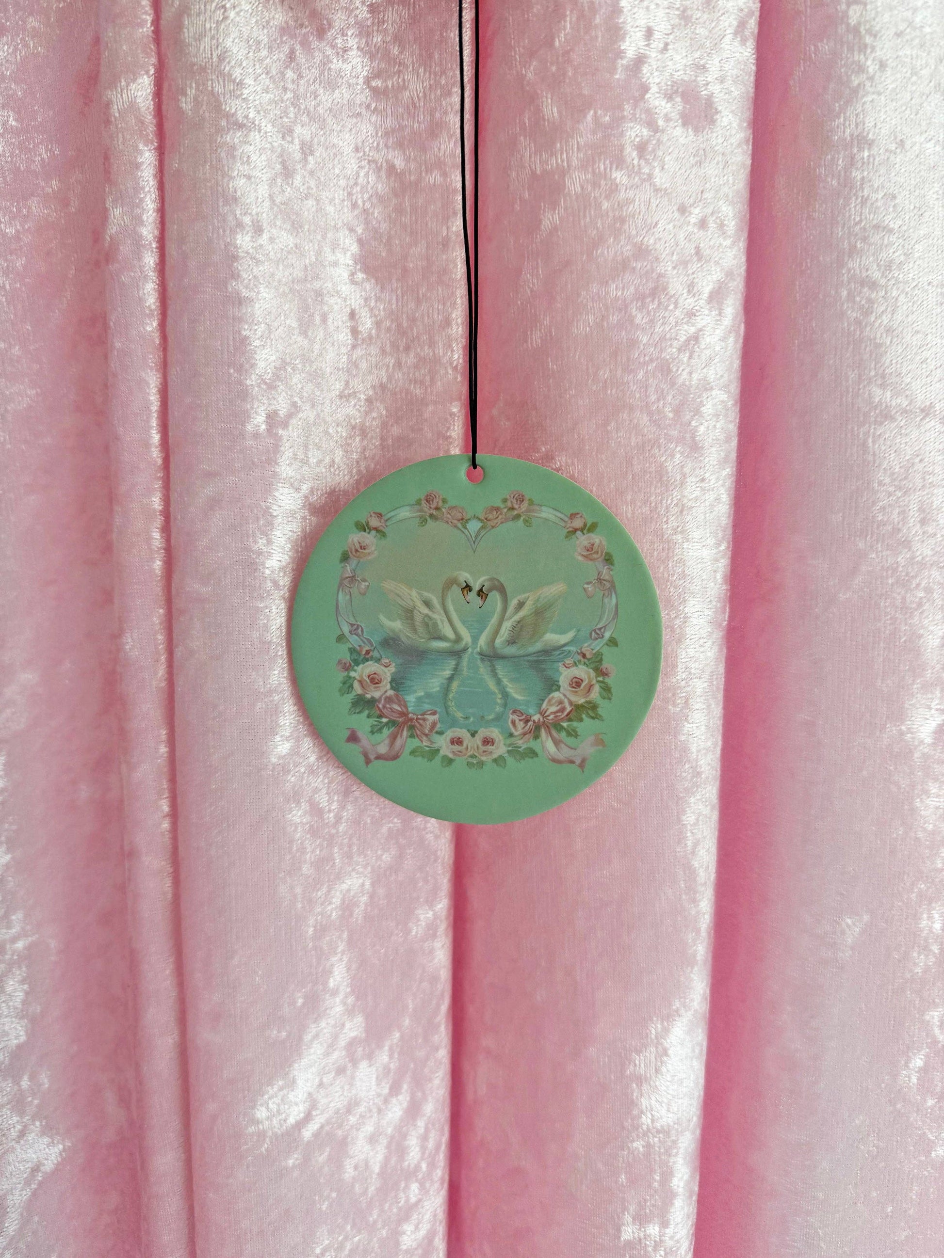 Sage green swan-themed car freshener, vanilla scented
