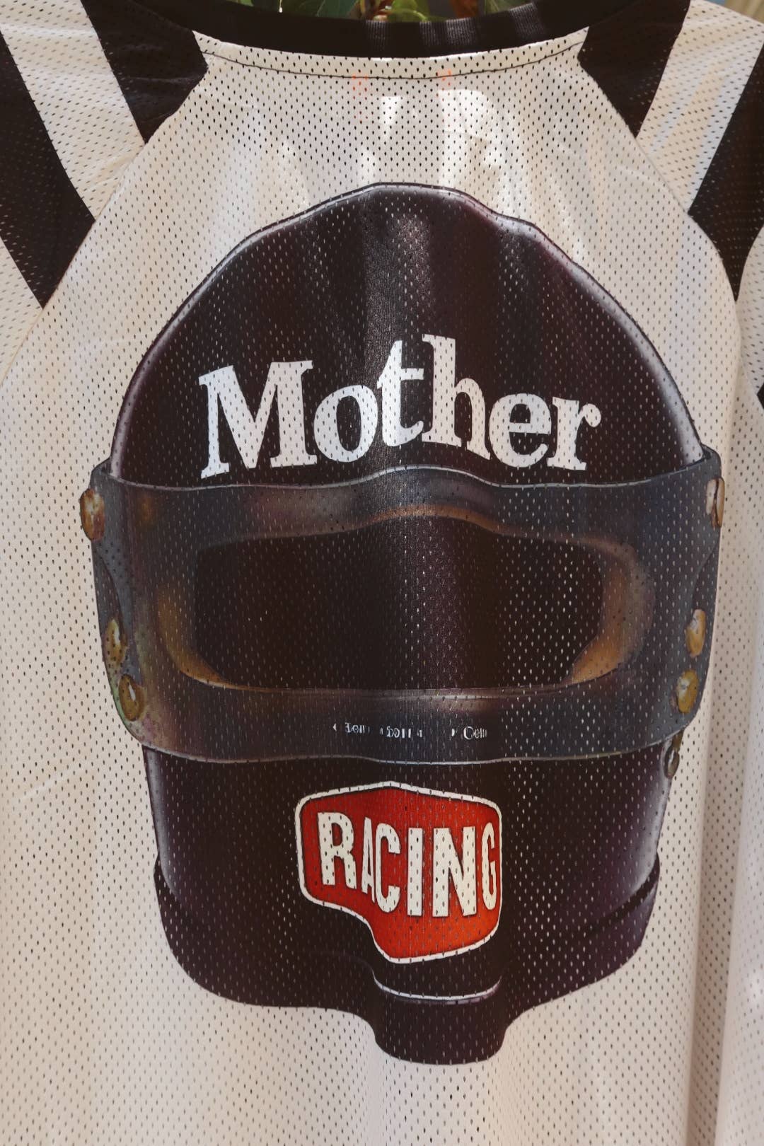 Oversized mesh racing jersey with bold black-and-white stripes and MOTHER arm patch